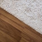 Close-up,White,Carpet,On,Laminate,Wood,Floor,In,Living,Room,