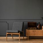 A,Gramophone,On,Wooden,Cabinet,And,Black,Chair,In,Dark